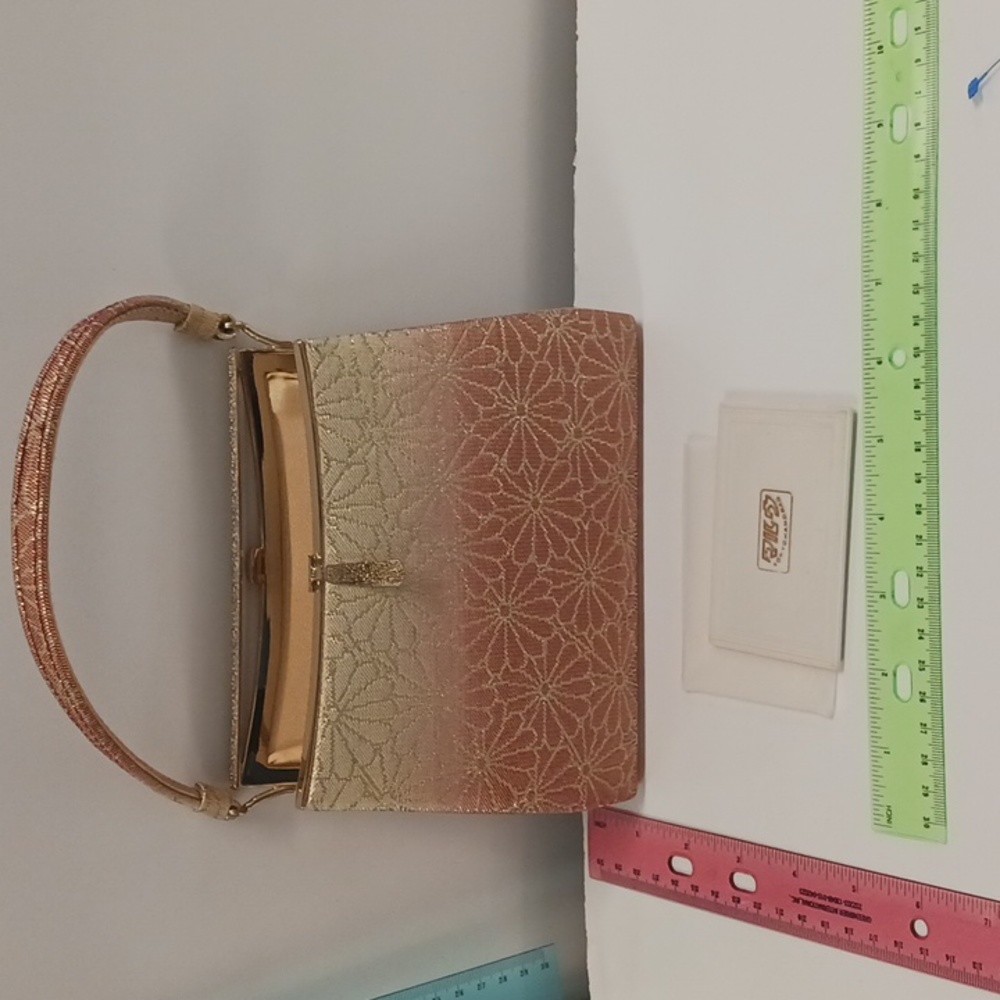 Formal Tokyo handbag gold and red with Gold Hardware and vanity mirror.